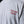 Close-up of a light gray t-shirt featuring 'TEXAS TECH wordmark screen-printed on the left chest