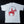off-White short-sleeve T-shirt shown from the back against a black background, featuring a large red graphic of a cowboy riding a horse with the text 'NOTHIN' PLAIN ABOUT IT' in blue arched above.